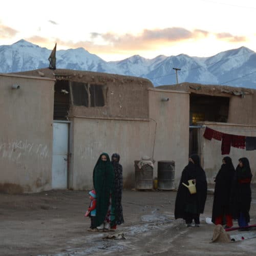 Afghan women refugees outside building